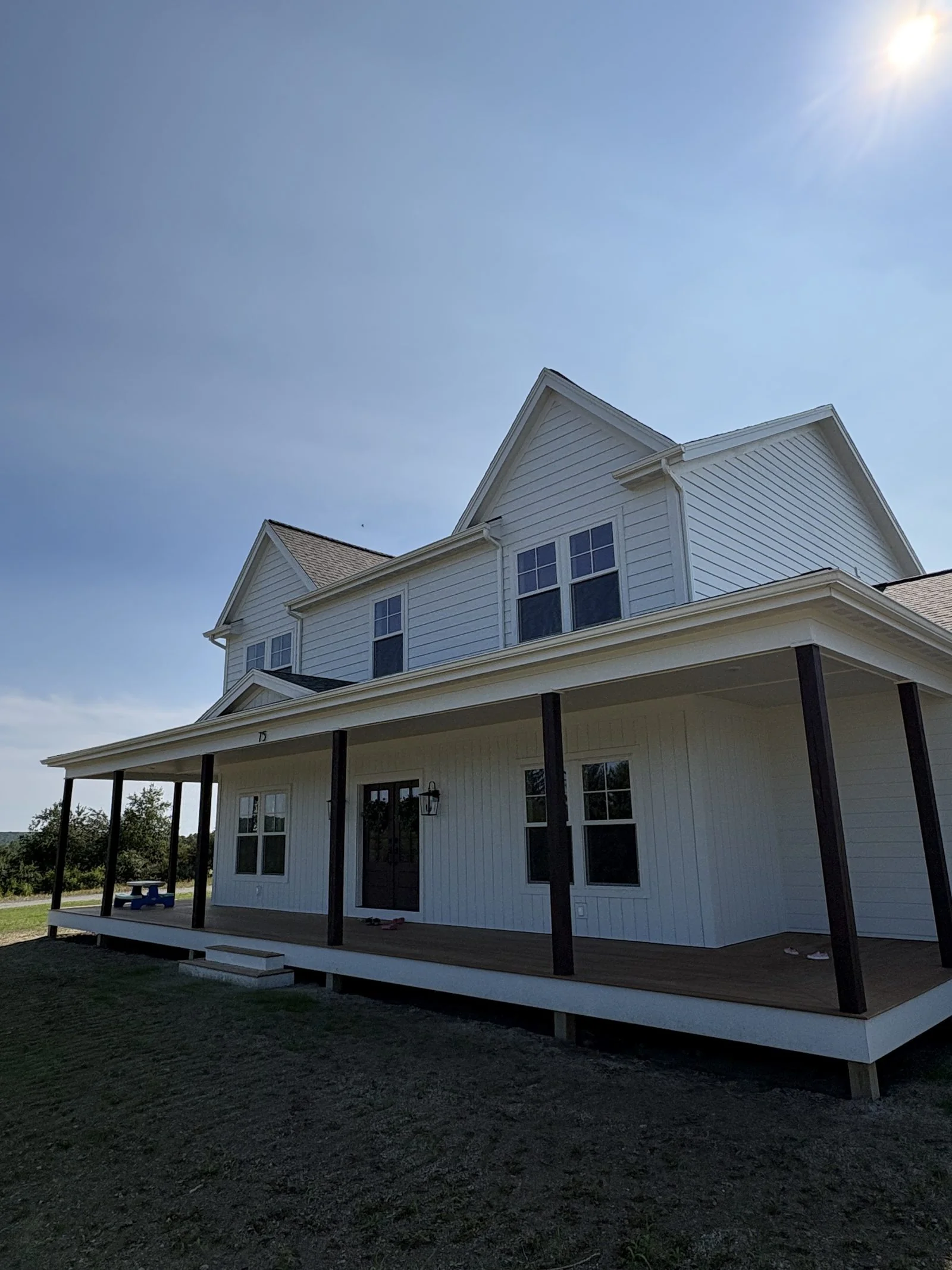 Custom farmhouse exterior with new siding