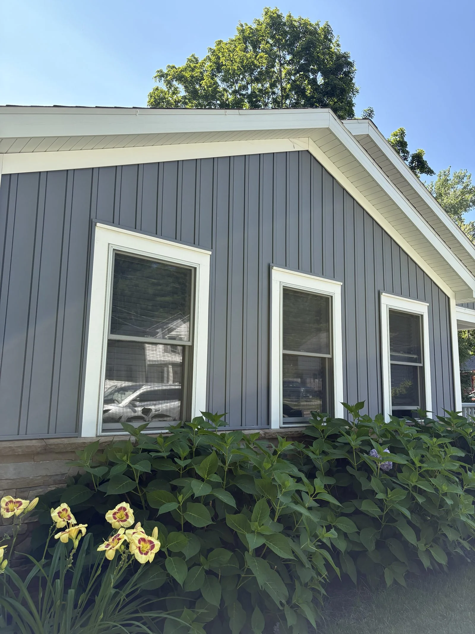 Siding and gable detail above a garden