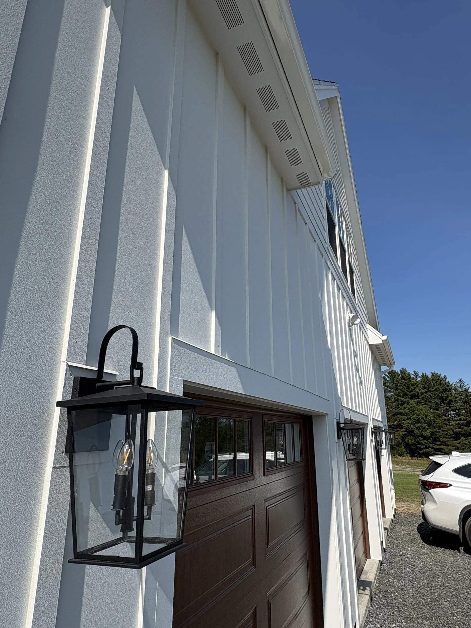 Garage with carriage-style door and coach lantern