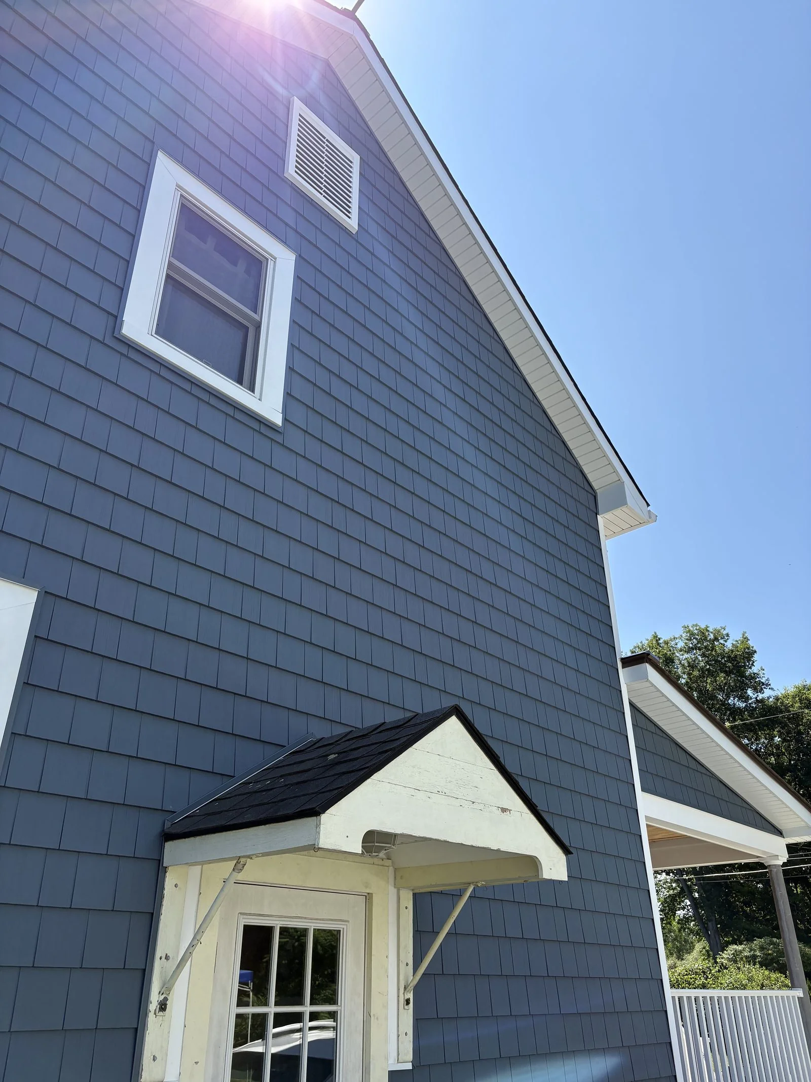 Siding and white trim detail on a custom home