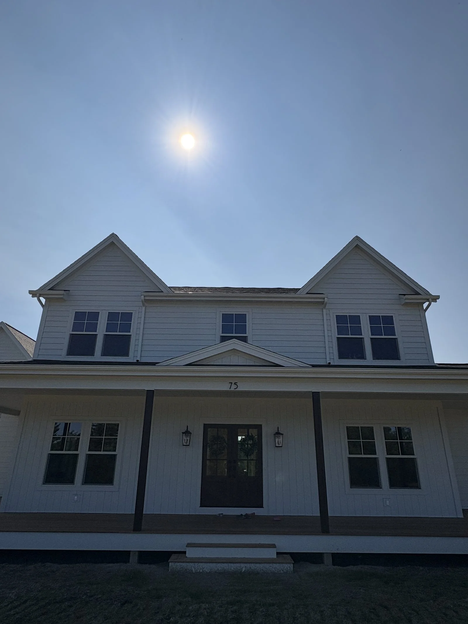 Board-and-batten farmhouse with covered front porch
