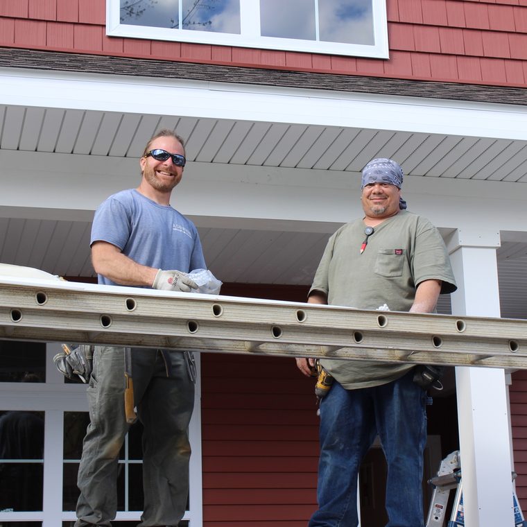 Two Vermac Construction team members on a siding project