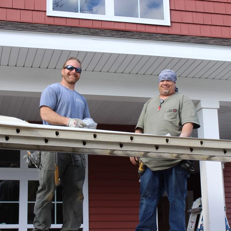 Two Vermac Construction team members on a siding project